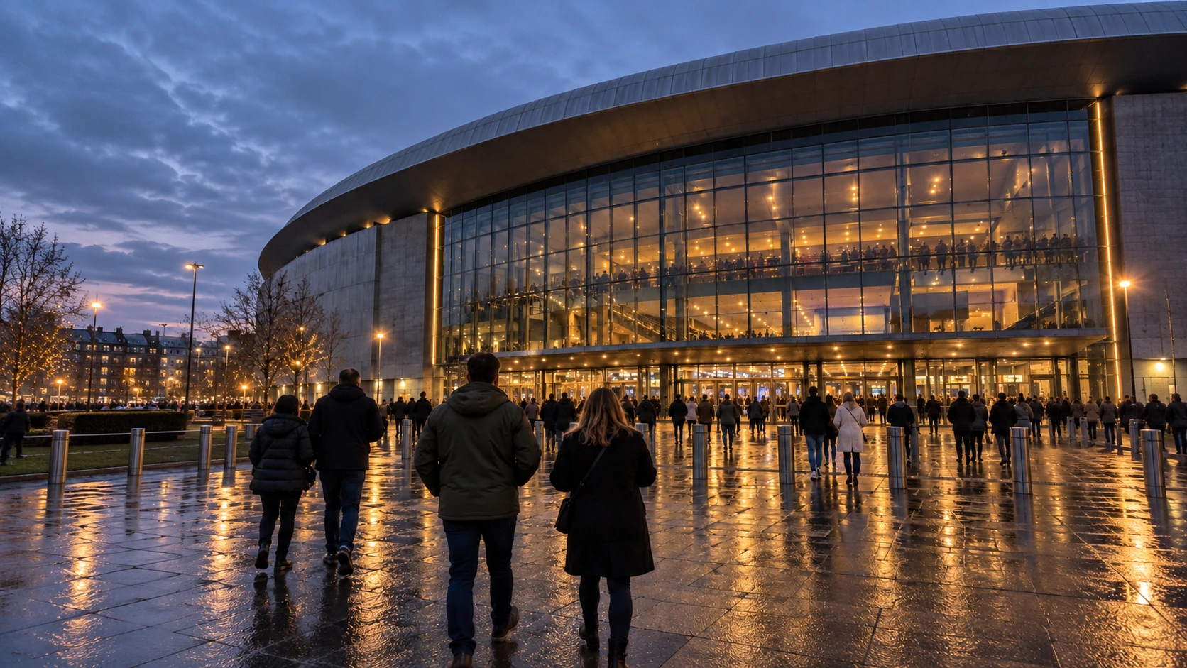 Concertgoers walking towards a UK arena at dusk before an André Rieu concert